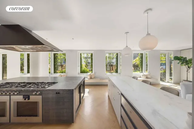 a dining hall with couches a coffee table and chairs with wooden floor