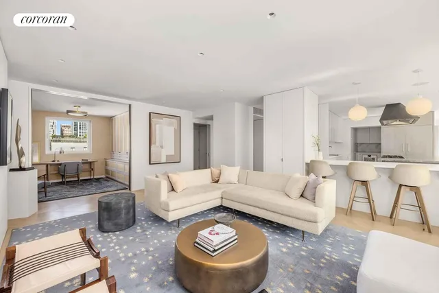 a dining room with furniture a chandelier and wooden floor
