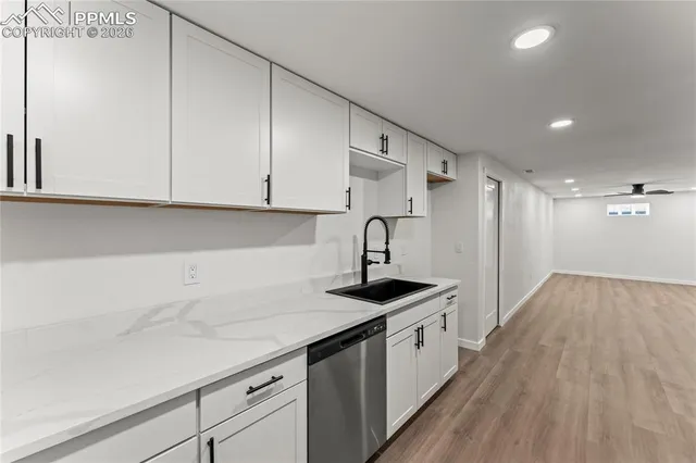 a kitchen with a sink and cabinets