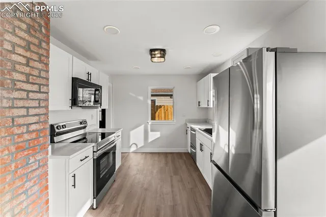 a kitchen with stainless steel appliances a refrigerator stove and microwave