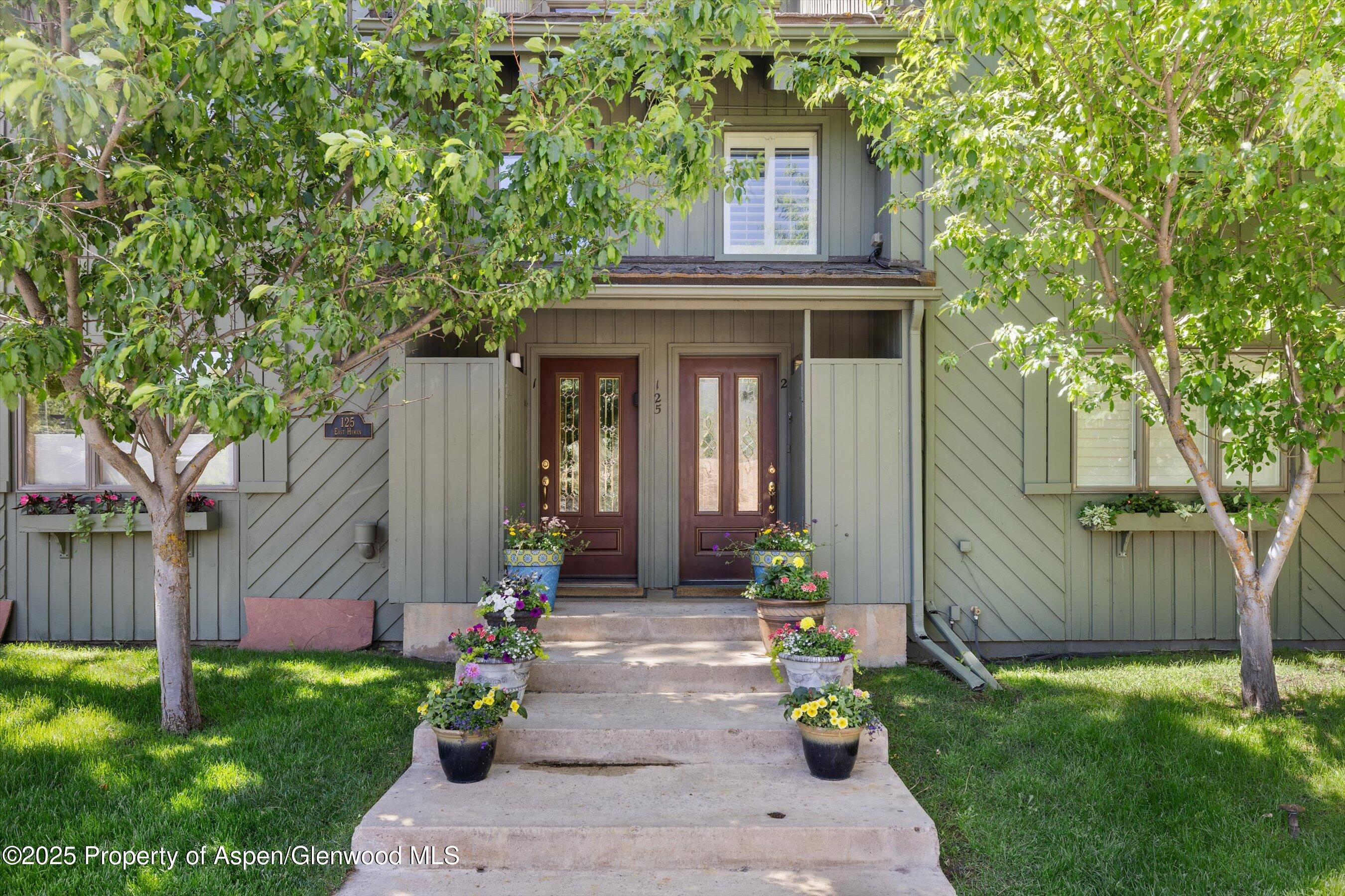 125 East Hyman Avenue, Unit 1A Aspen, CO 81611 - Photo 14 of 19 a front view of a house with garden