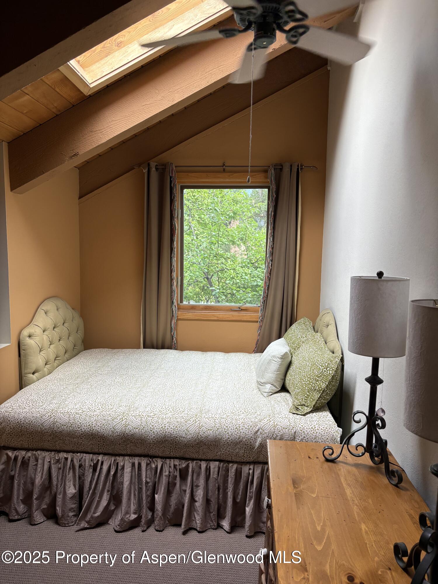 125 East Hyman Avenue, Unit 1A Aspen, CO 81611 - Photo 7 of 19 a bedroom with a bed and a window