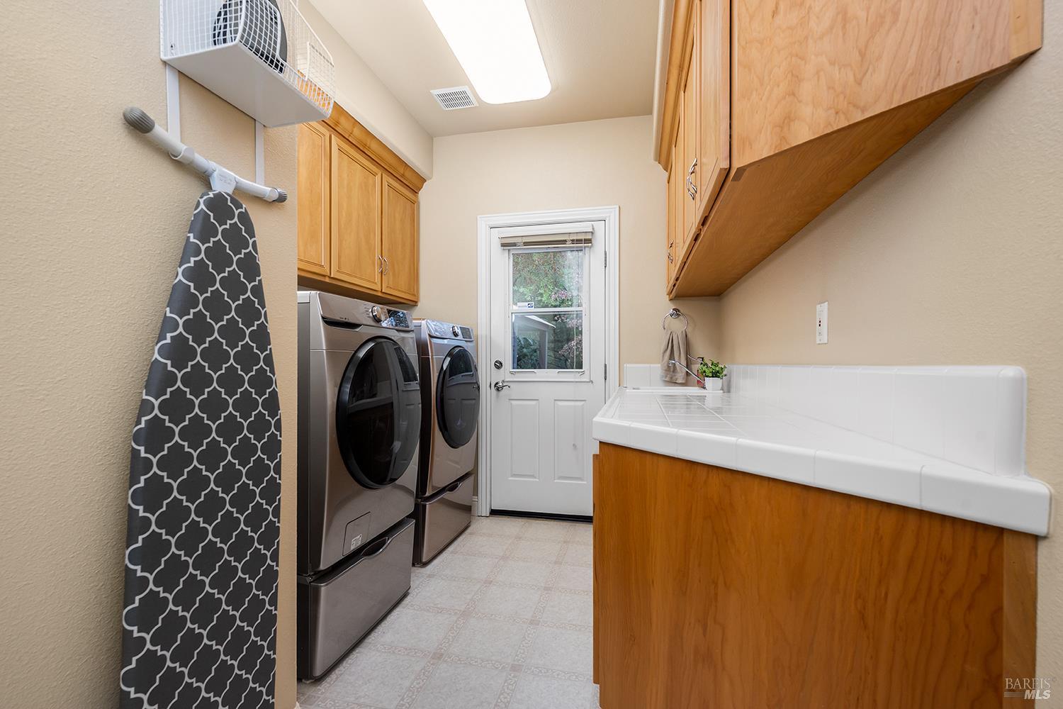 3696 Newbury Court Santa Rosa, CA 95404 - Photo 37 of 52 a bathroom with a sink a washer and dryer