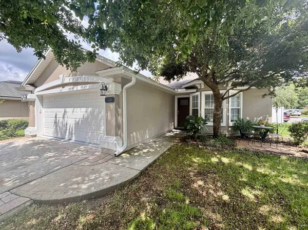 a view of a house with yard and tree s