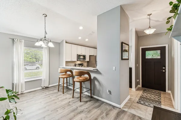 a kitchen with stainless steel appliances a stove refrigerator sink and microwave