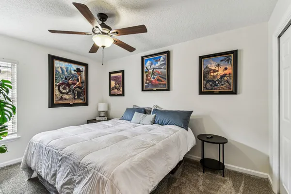 a bathroom with a granite countertop sink a toilet and shower