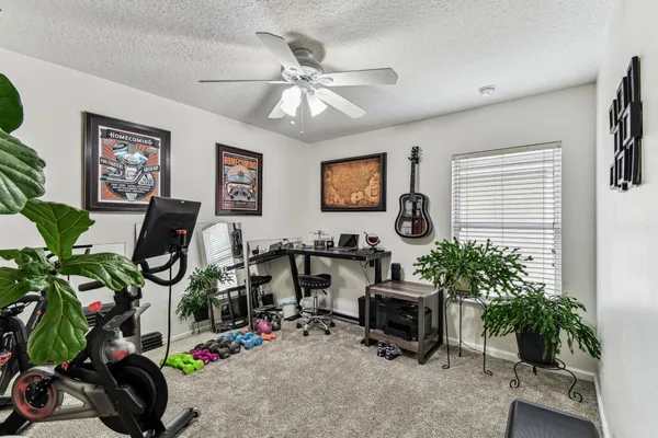 a view of a hallway with workspace and a window