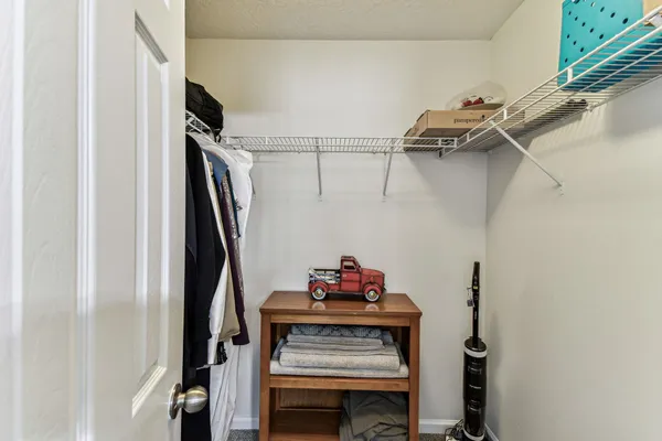 a view of a livingroom with furniture and floor to ceiling window