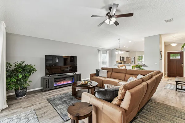 a living room with fireplace furniture and a wooden floor