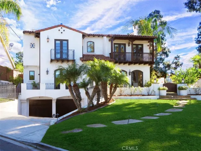 a front view of a house with a yard garage and sitting area