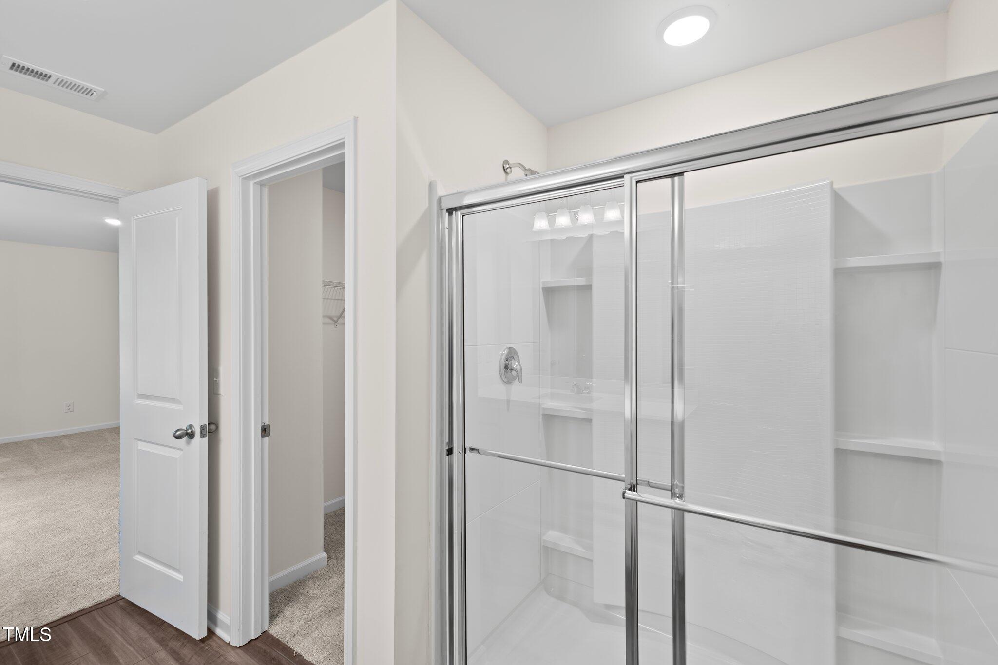 1200 Solace Way Rolesville, NC 27571 - Photo 13 of 24 a bathroom with a glass shower door