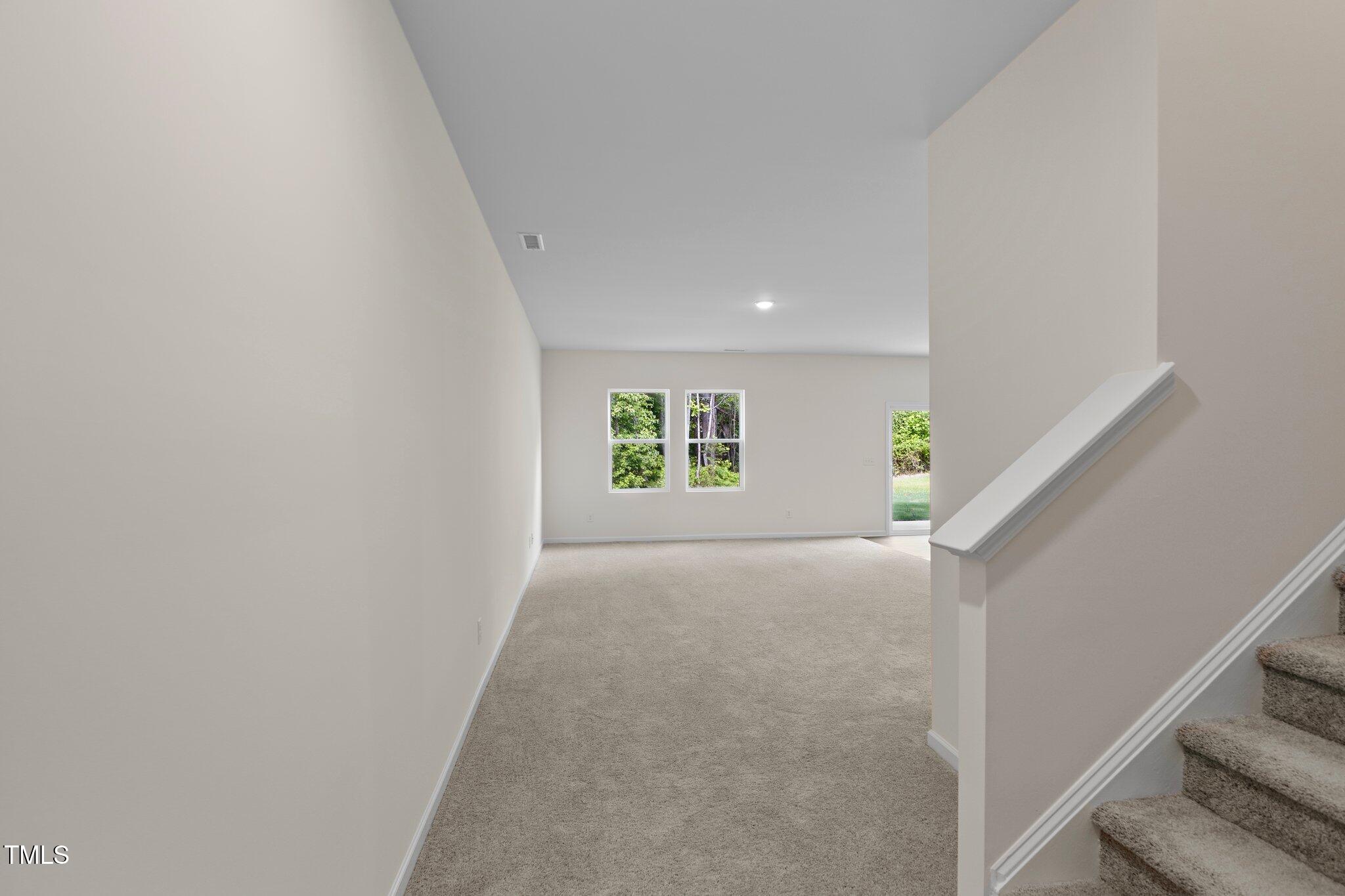 1200 Solace Way Rolesville, NC 27571 - Photo 3 of 24 a view of a hallway with white walls and a window