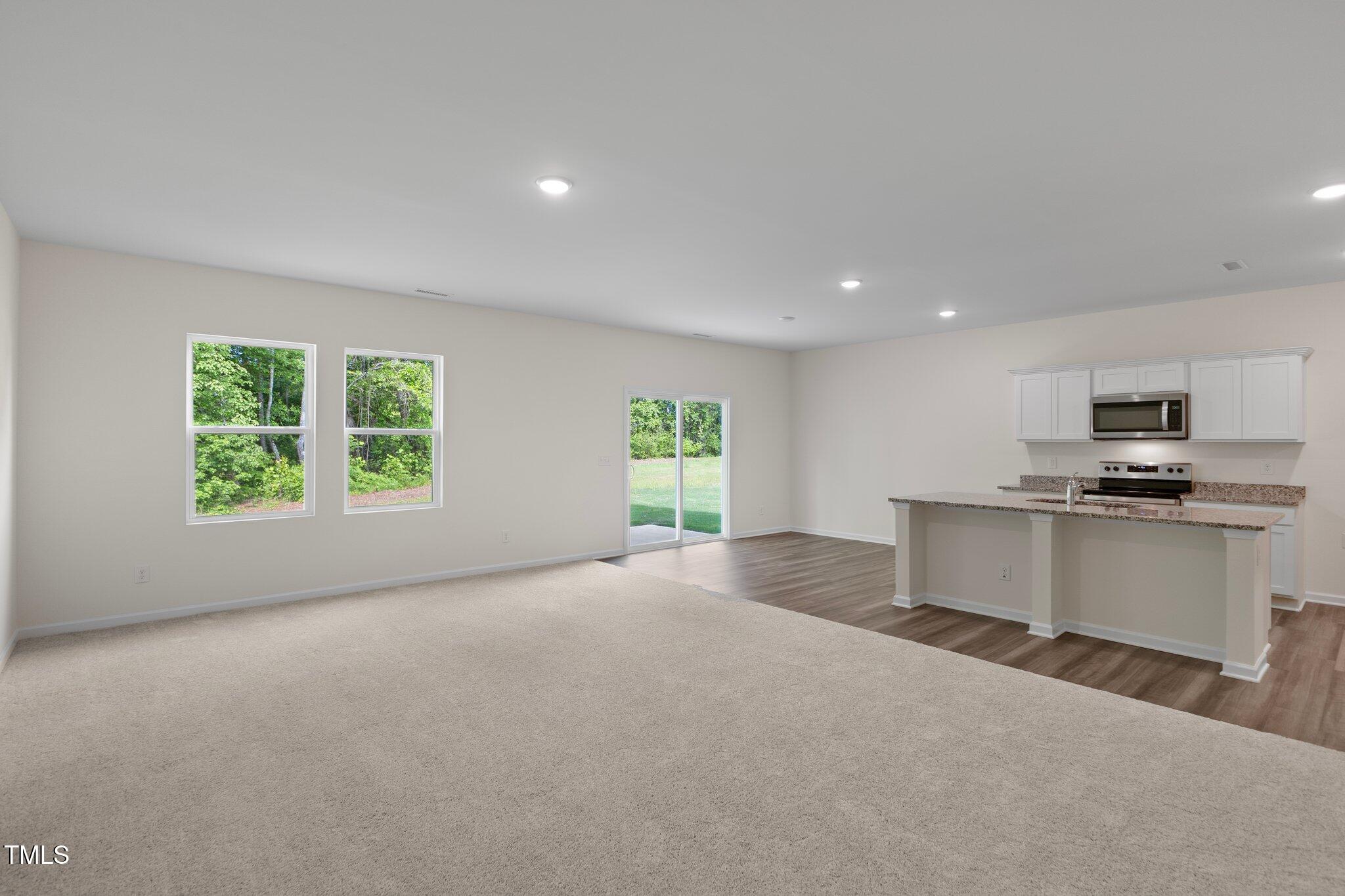 1200 Solace Way Rolesville, NC 27571 - Photo 4 of 24 a view of kitchen with kitchen island stainless steel appliances a window and a counter top space