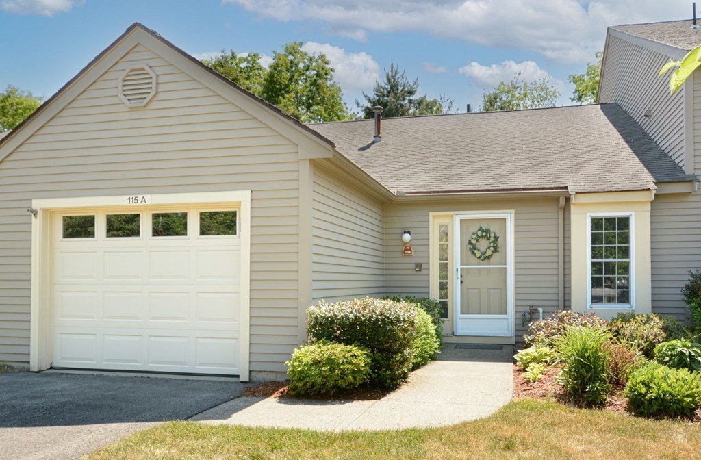 115 Ridgefield Circle, Unit A Clinton, MA 01510 - Photo 1 of 16 a view of a backyard with plants