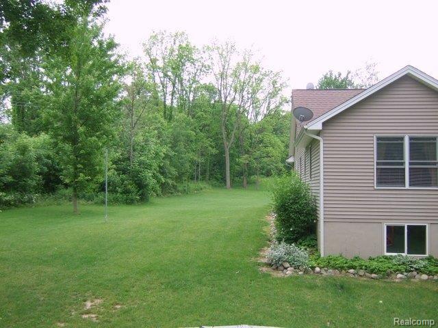 5758 Mason Road Fowlerville, MI 48836 - Photo 6 of 25 Side view w/woods