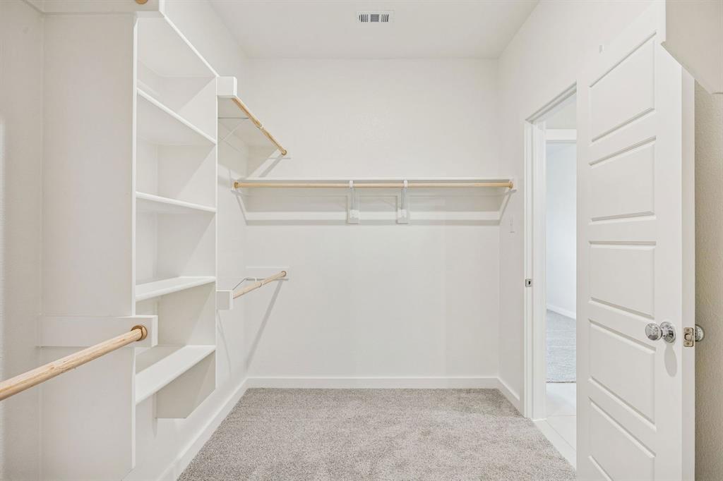 5719 Rushing River Way McKinney, TX 75071 - Photo 29 of 40 Primary Closet in the Stanley II home plan by Trophy Signature Homes – REPRESENTATIVE PHOTO