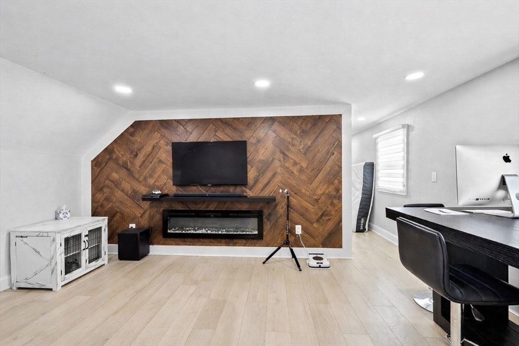 137 Westboro Road Grafton, MA 01536 - Photo 24 of 28 a living room with furniture flat screen tv and a fireplace