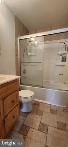 a bathroom with a toilet a sink and shower
