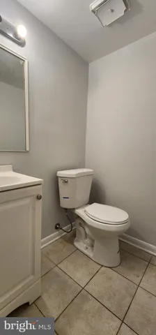 a white toilet sitting next to a bathroom sink