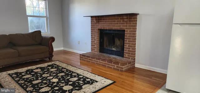 a living room with a rug and a fireplace