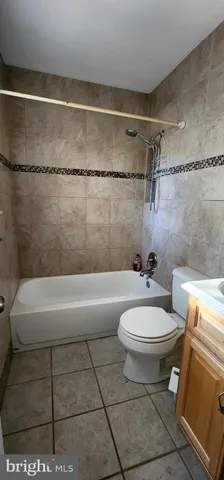 a bathroom with a toilet a sink and bathtub