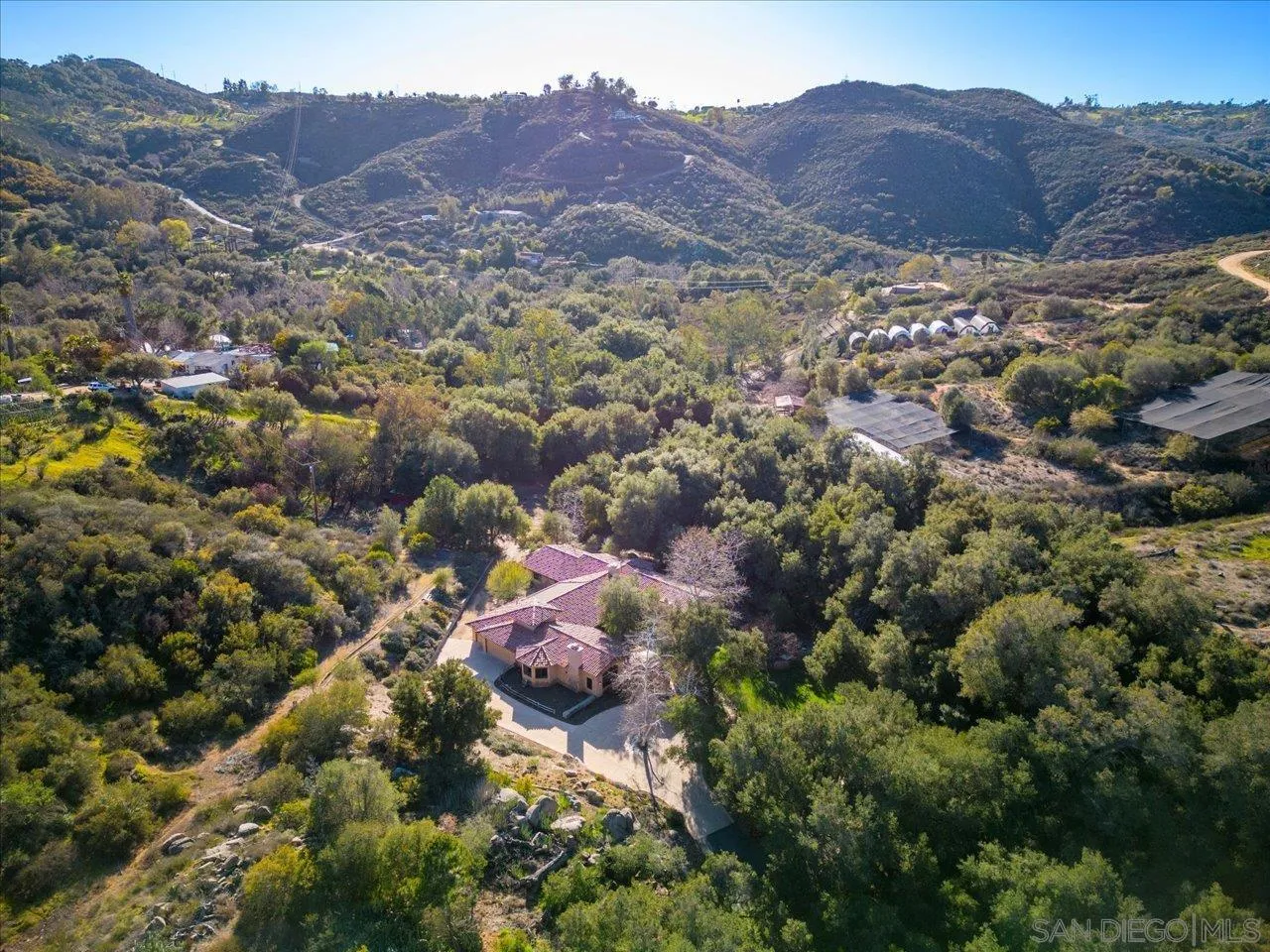 11760 Betsworth Road Valley Center, CA 92082 - Photo 1 of 47 a view of a lush green hillside and houses