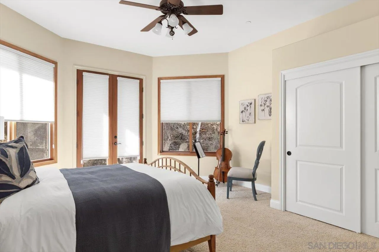 11760 Betsworth Road Valley Center, CA 92082 - Photo 16 of 47 a bedroom with a bed a couch and large window