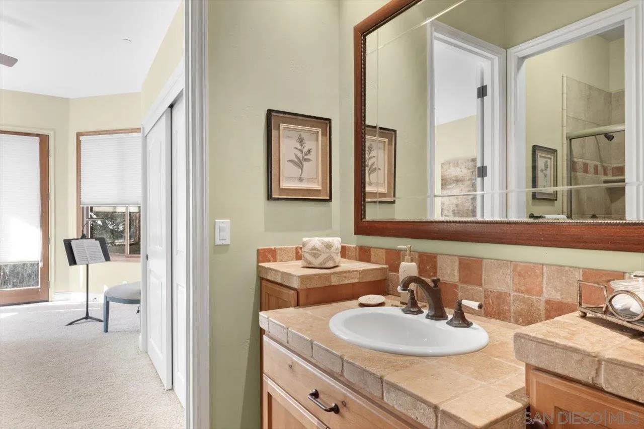 11760 Betsworth Road Valley Center, CA 92082 - Photo 17 of 47 a bathroom with a sink and a mirror