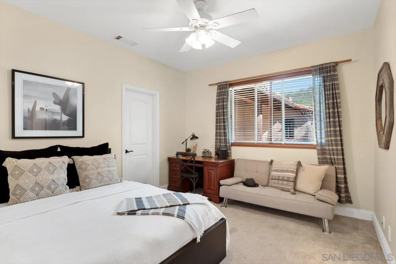 11760 Betsworth Road Valley Center, CA 92082 - Photo 18 of 47 a bedroom with a bed and a couch