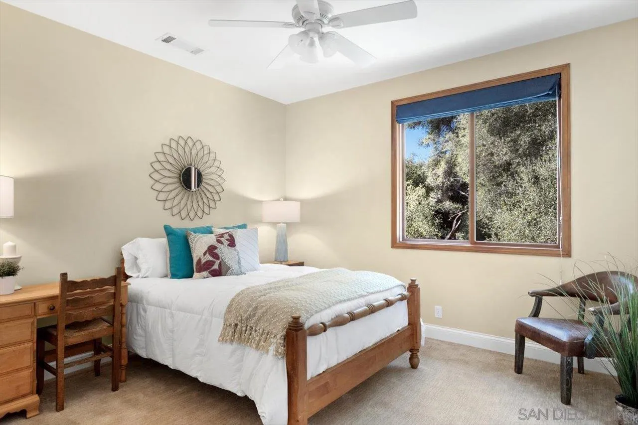 11760 Betsworth Road Valley Center, CA 92082 - Photo 22 of 47 a bedroom with a bed and a chair