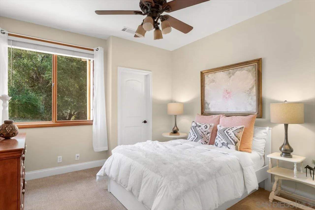 11760 Betsworth Road Valley Center, CA 92082 - Photo 24 of 47 a bedroom with a large bed and a window
