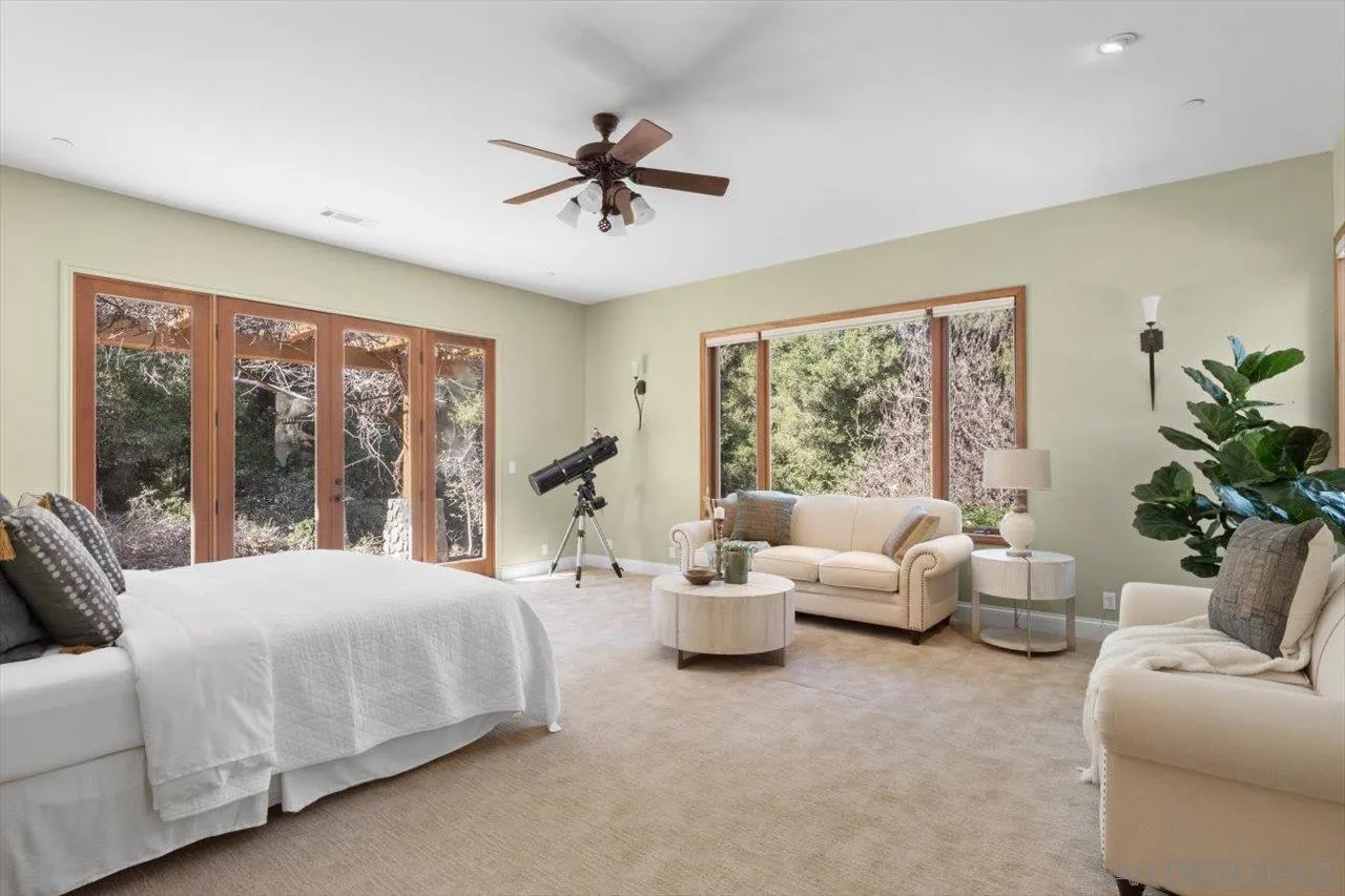 11760 Betsworth Road Valley Center, CA 92082 - Photo 26 of 47 a bedroom with a large bed and a couch