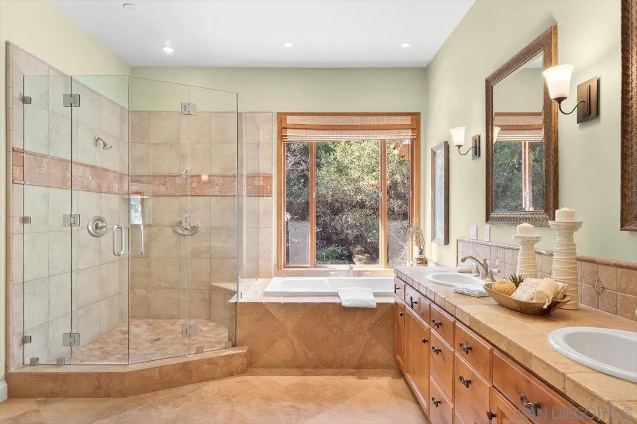 11760 Betsworth Road Valley Center, CA 92082 - Photo 30 of 47 a bathroom with a granite countertop sink mirror and shower