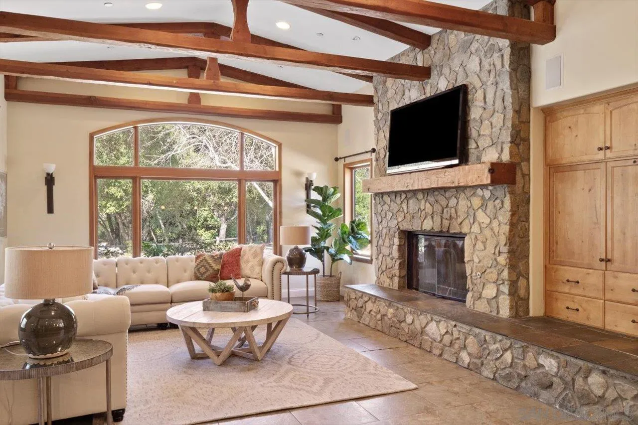 11760 Betsworth Road Valley Center, CA 92082 - Photo 7 of 47 a living room with furniture a fireplace and a flat screen tv