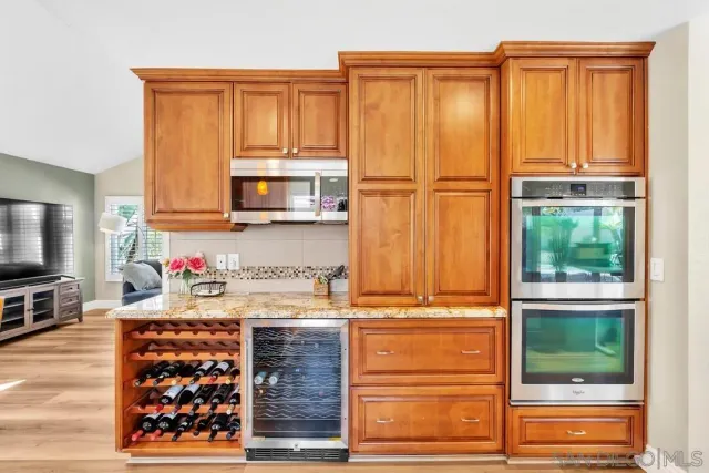 a kitchen with stainless steel appliances granite countertop a refrigerator and a microwave