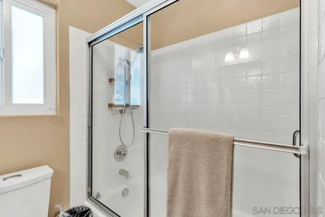 a bathroom with a shower and a toilet