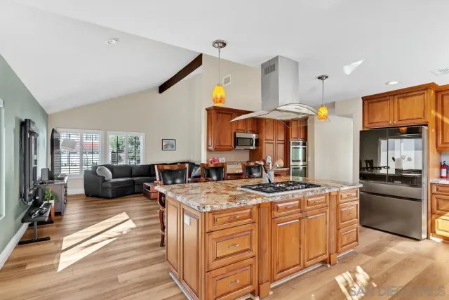 a kitchen with stainless steel appliances granite countertop a stove and a sink