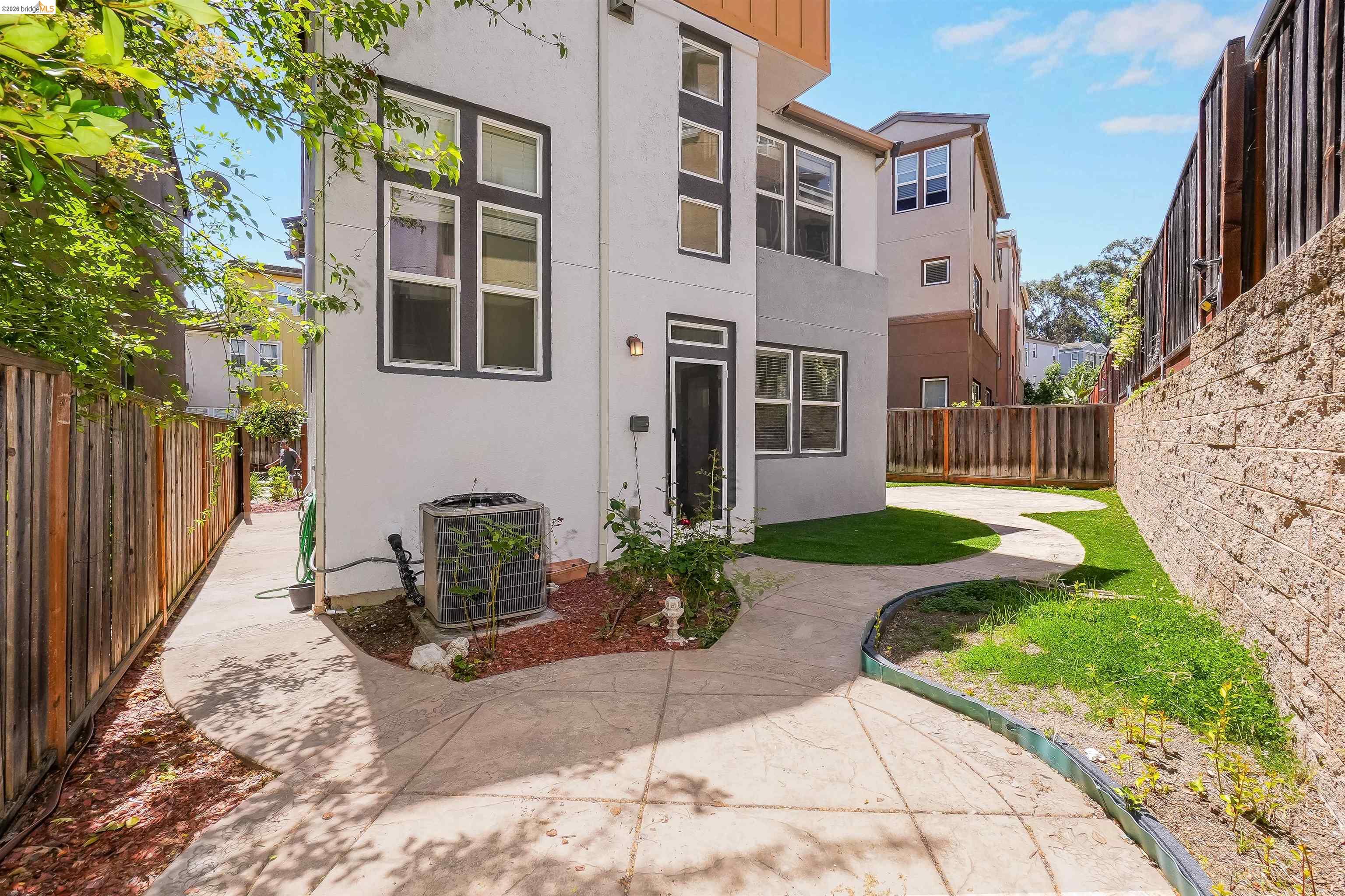 449 Constantine Court San Ramon, CA 94583 - Photo 55 of 63 Rear exterior featuring a white stucco finish, dark framed windows, and a concrete patio