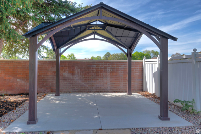 16 Gatehouse Lane Sandy, UT 84092 - Photo 55 of 73 Fenced backyard featuring a gazebo and a patio