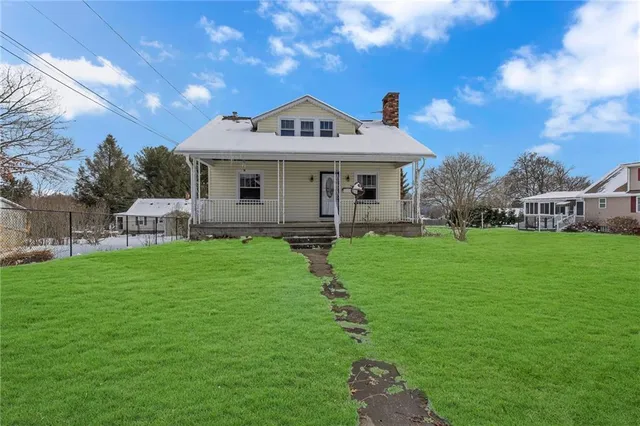 a front view of a house with garden