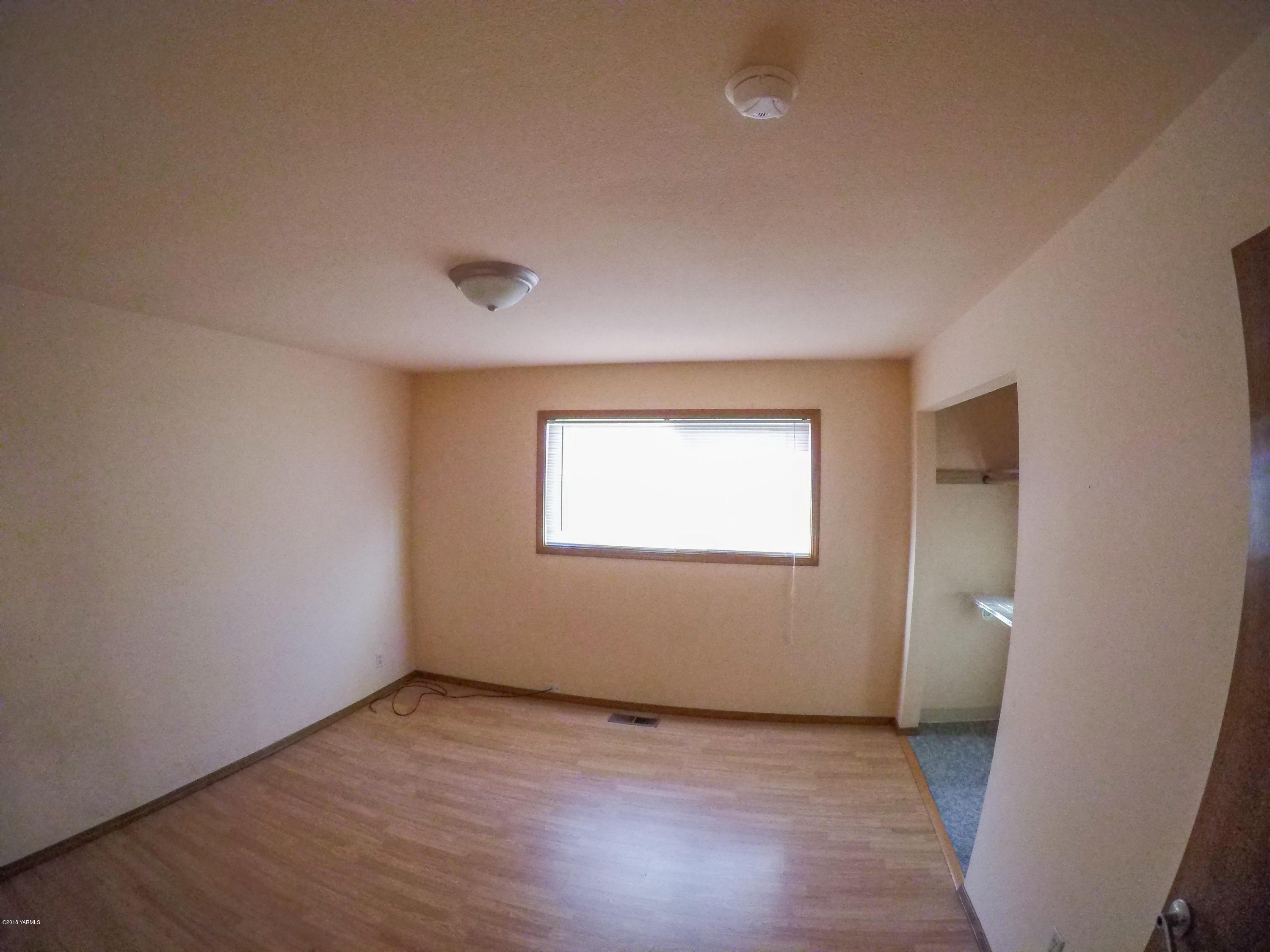 13406 Summitview Ext Road Yakima, WA 98908 - Photo 15 of 26 an empty room with wooden floor and windows