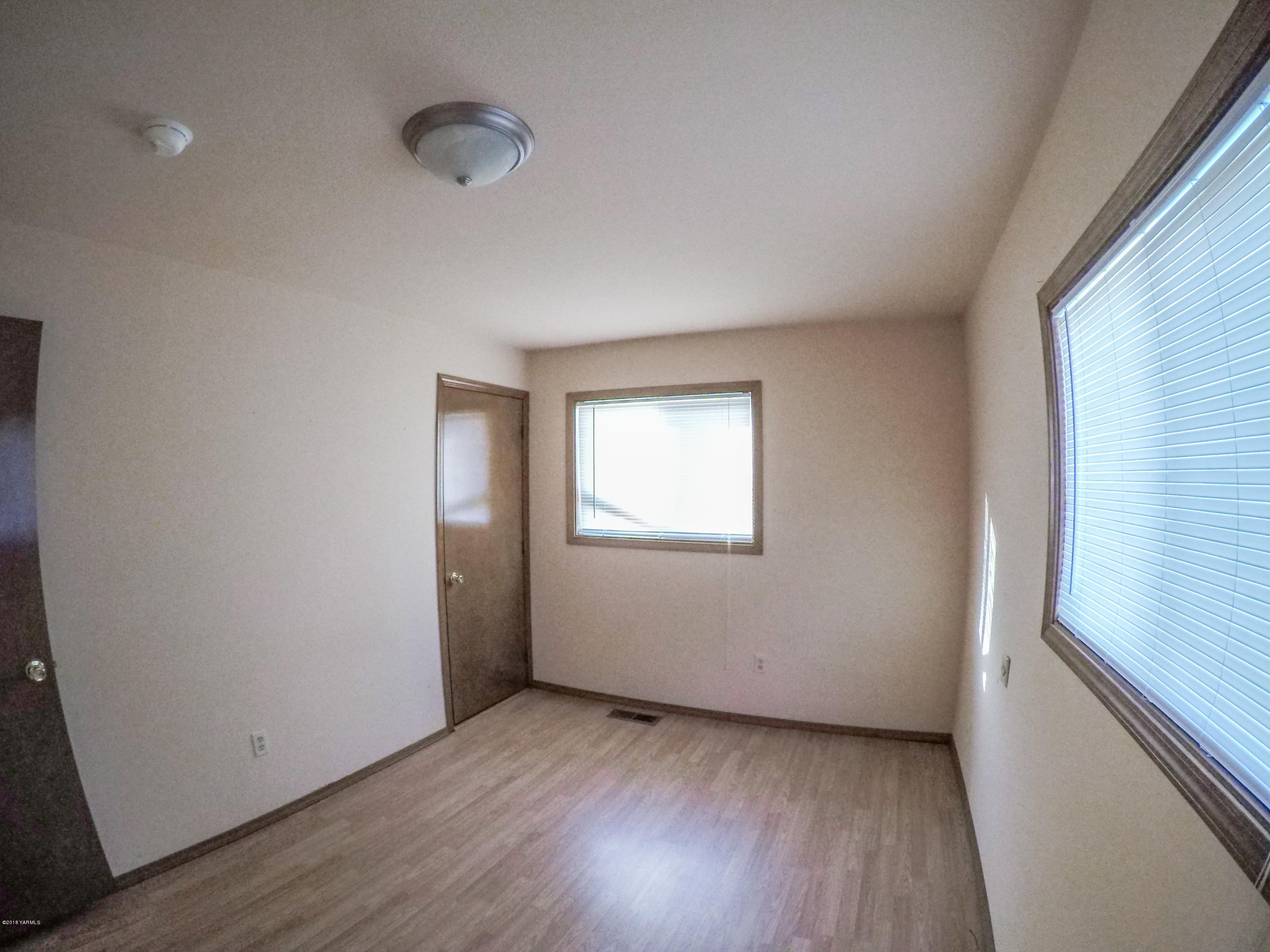 13406 Summitview Ext Road Yakima, WA 98908 - Photo 17 of 26 a view of an empty room with wooden floor and a window