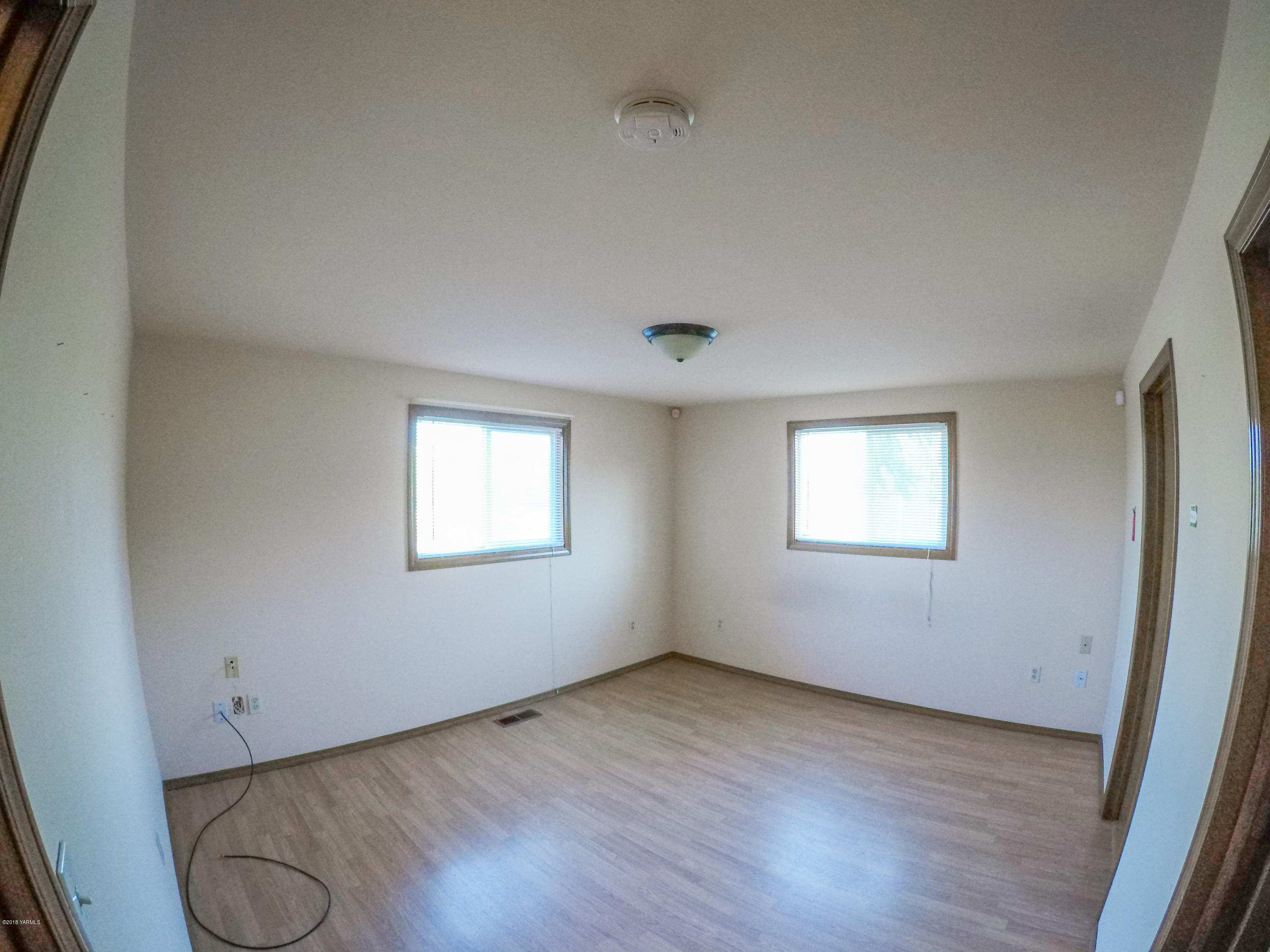 13406 Summitview Ext Road Yakima, WA 98908 - Photo 19 of 26 an empty room with wooden floor and windows