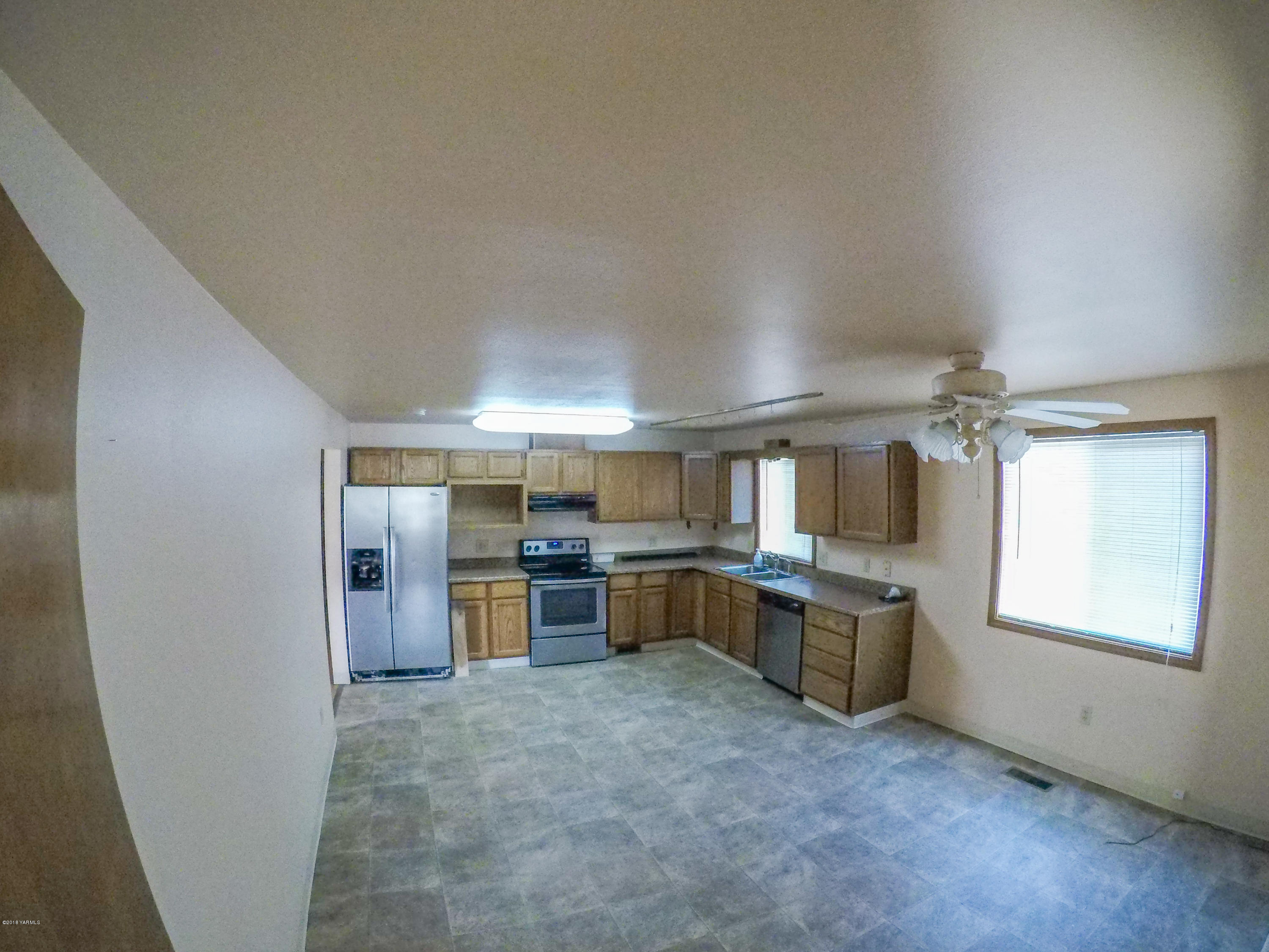 13406 Summitview Ext Road Yakima, WA 98908 - Photo 10 of 26 wooden floor with a kitchen and a window