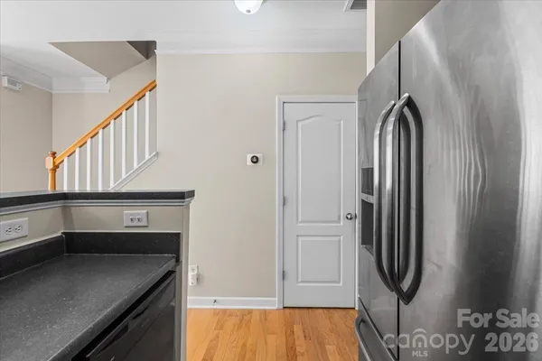 a kitchen with stainless steel appliances granite countertop a refrigerator and a sink