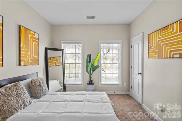 a living room with furniture and large windows