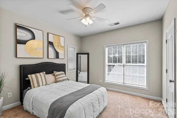 a bedroom with a bed and a large mirror