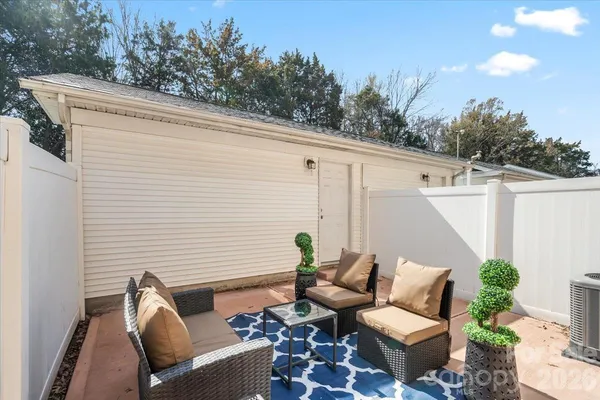 a view of a patio with couches chairs and wooden floor