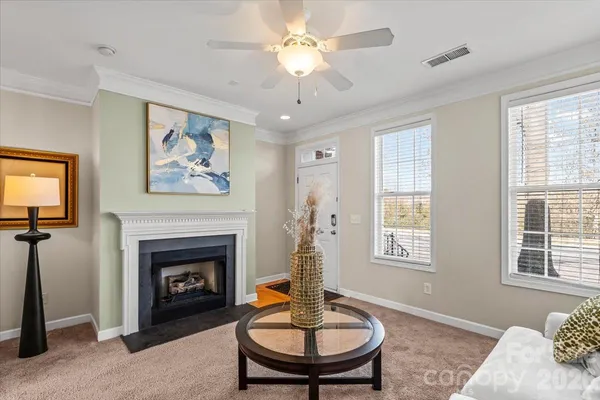 a living room with furniture a fireplace and a flat screen tv