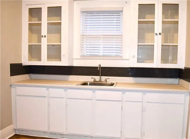 a living room with a large window and sink